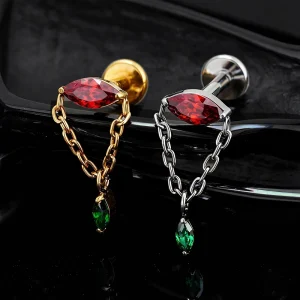 Titanium hidden helix piercing in gold and silver with red and green stones dangling chain earring